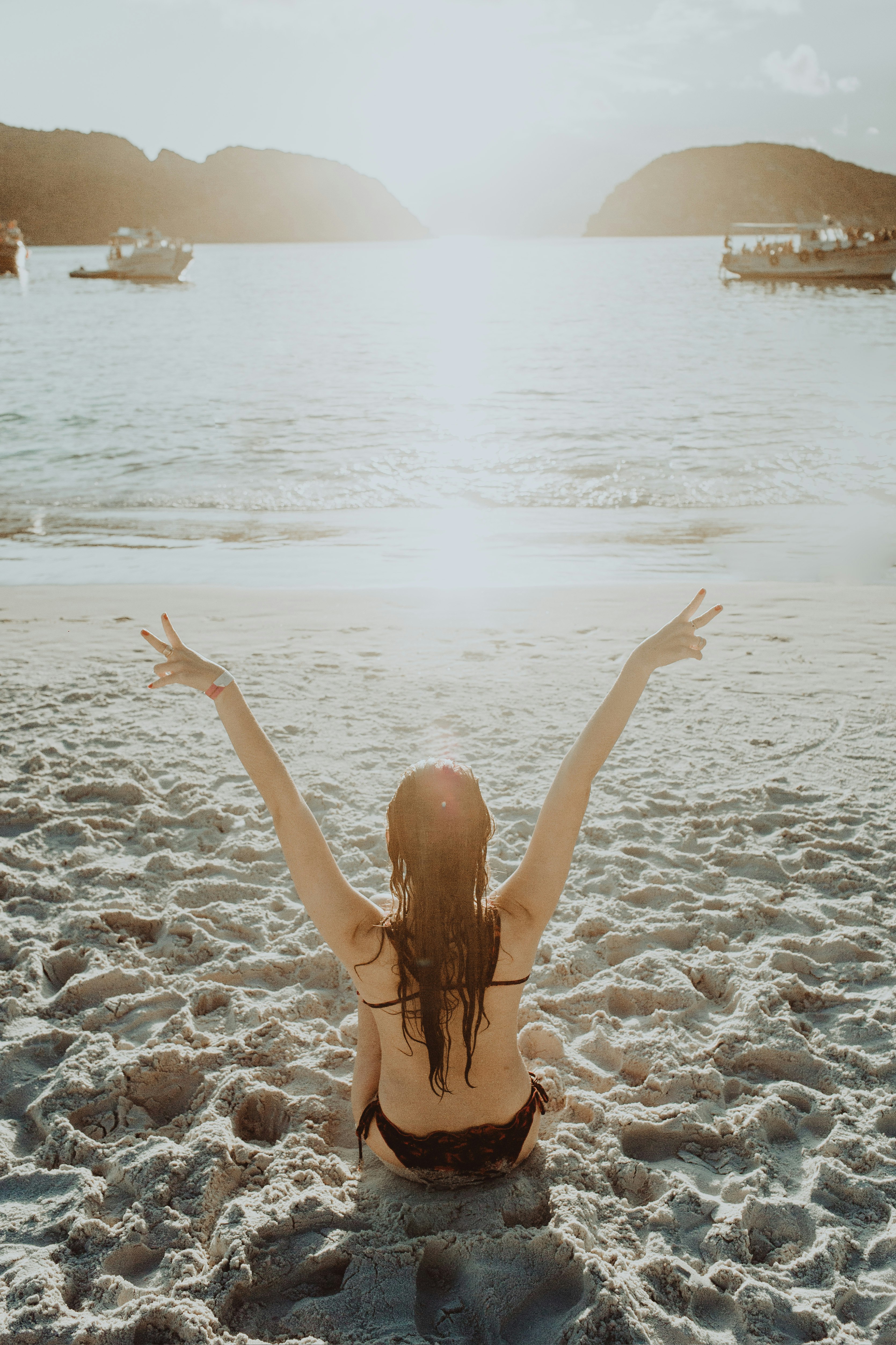 woman in black bikini bottom on beach during daytime